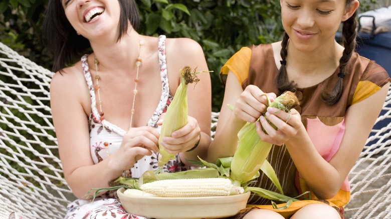 Shucking corn outside