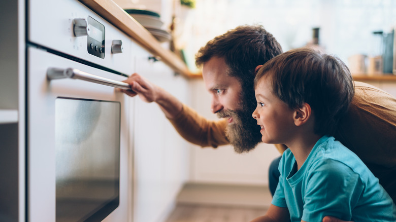 People looking into oven door