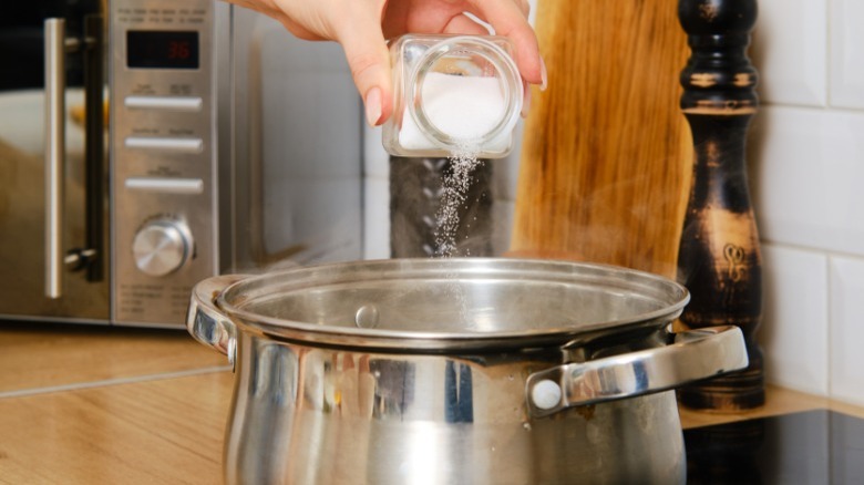 adding salt to boiling water