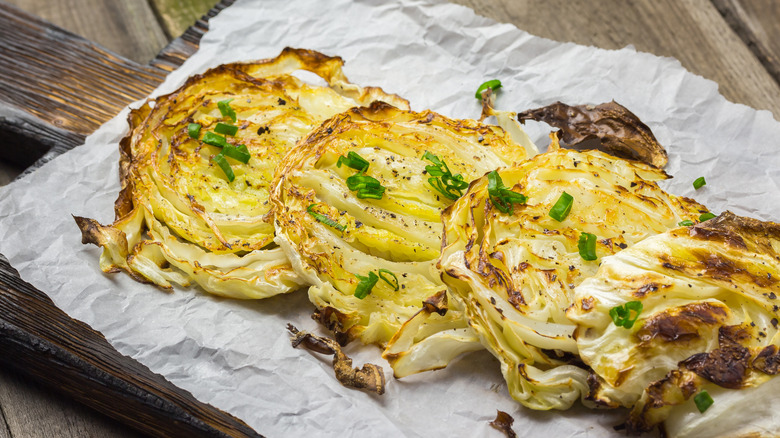 Sliced roasted cabbage on board