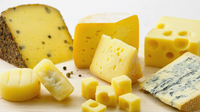 Assorted cheese on cutting board