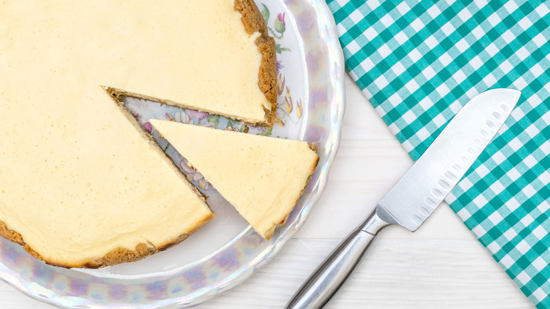 Cutting cheesecake with knife