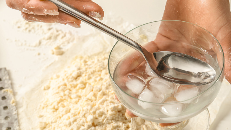 Person spooning ice water