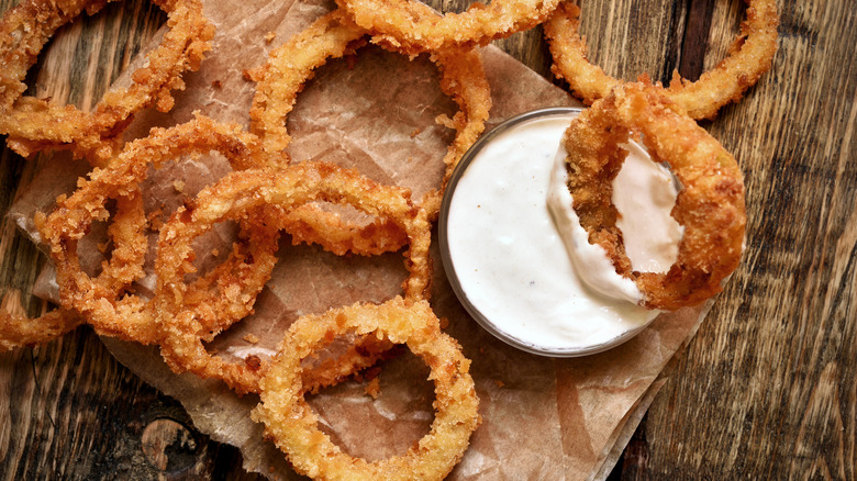 dipping onion ring in sauce