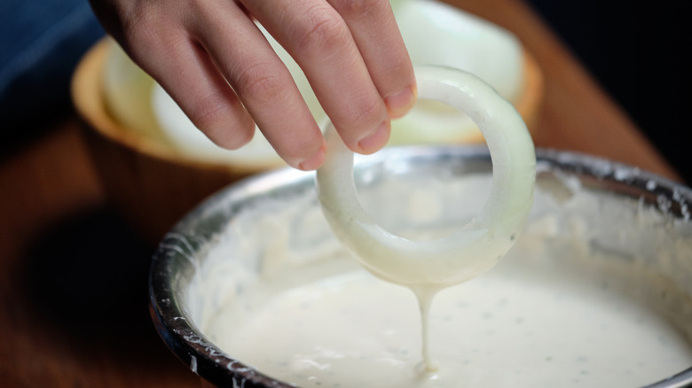 dredging onion ring in buttermilk