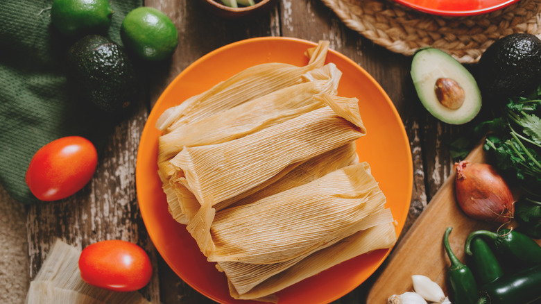 Tamales on plate with toppings