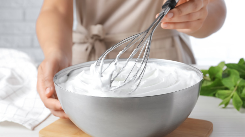 Person whipping cream by hand