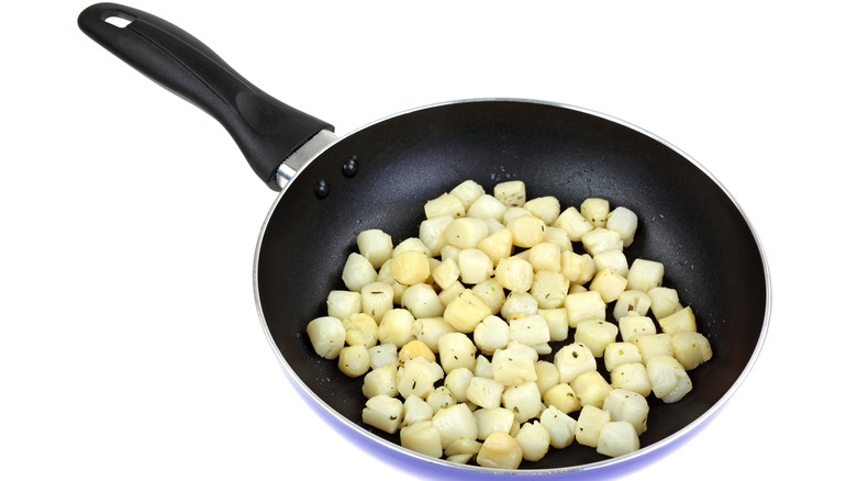 Bay scallops in frying pan