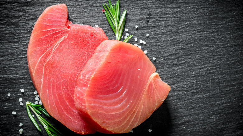 Fresh tuna steaks black background