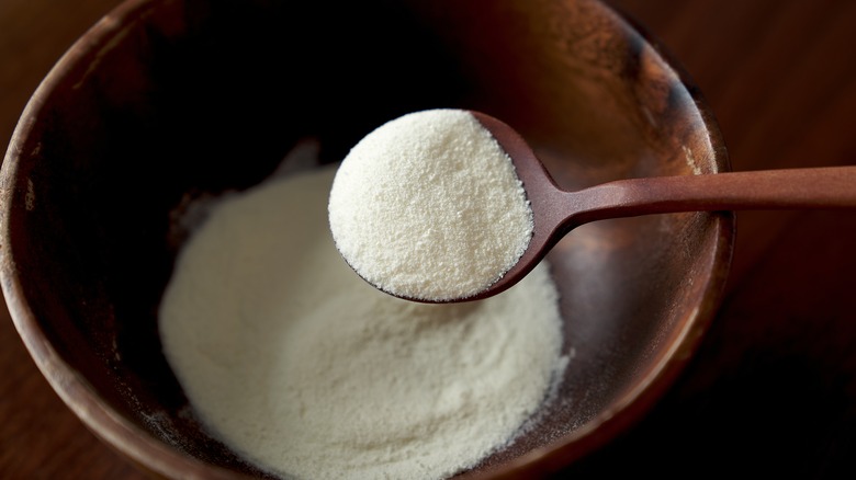 Milk powder in wooden bowl