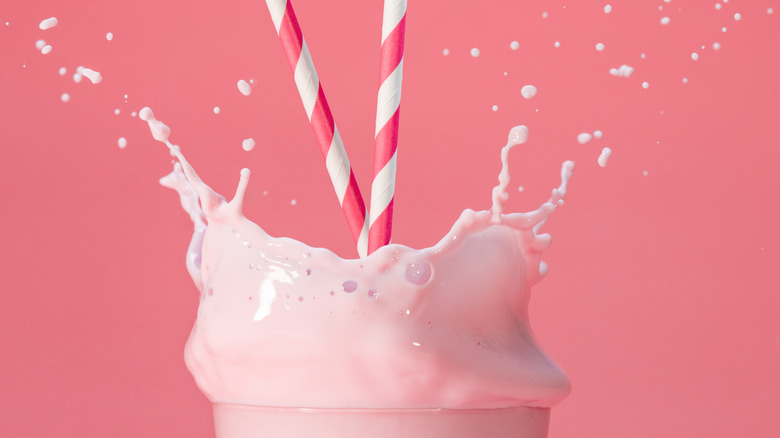 Strawberry milkshake on pink background