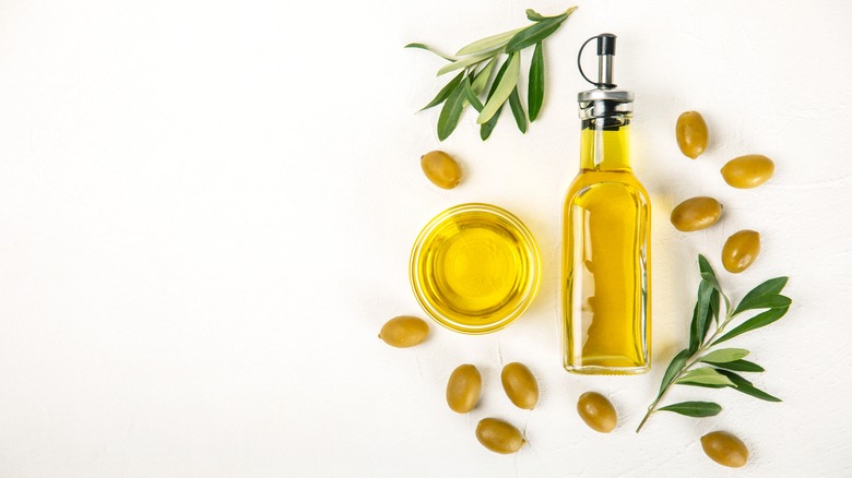 Bottle of olive oil with olives