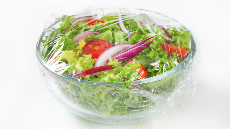 glass salad bowl wrapped completely in plastic