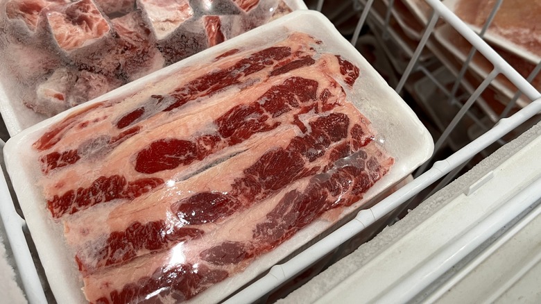 meat wrapped in plastic in freezer