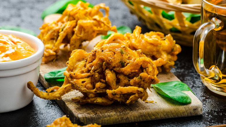 Onion pakora on wooden board