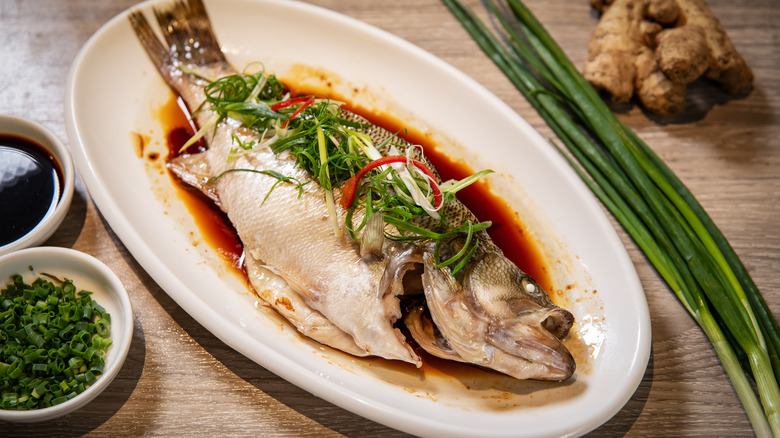 Whole steamed fish with garnish