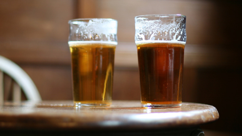 Nonic pint glasses of beer on table