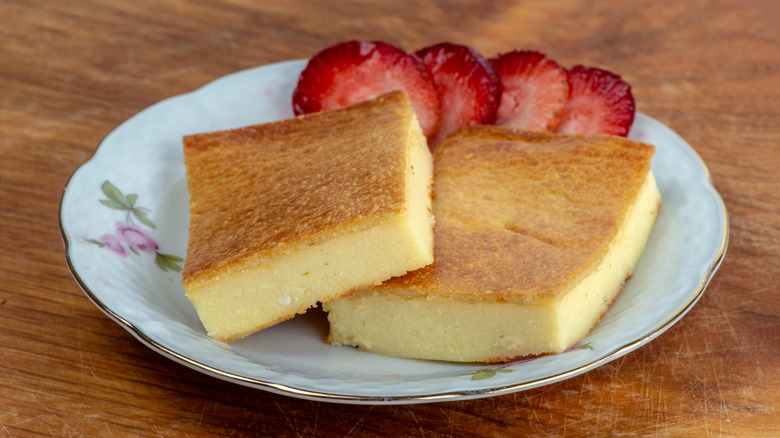 Fiadone cheesecake on white plate with strawberry slices