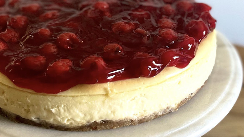 Philly-style cheesecake with fruit topping on marble board