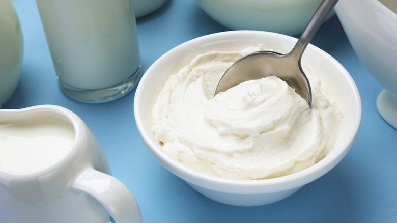 Whipped cream in bowl with spoon