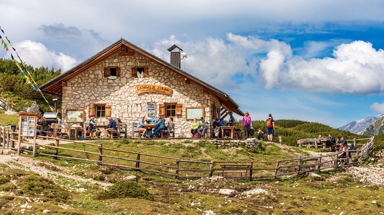 Alpine mountain refuge with hikers