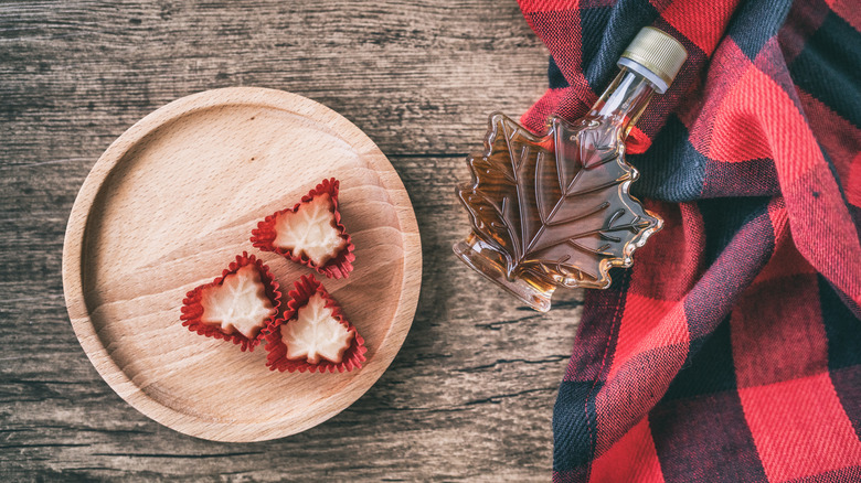 Maple candies on wooden plate