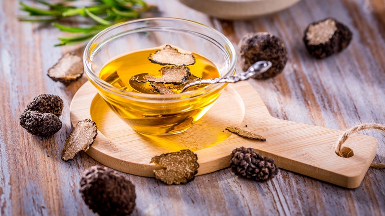 Oil in bowl surrounded by truffles 