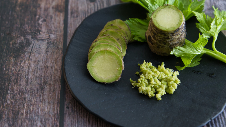 Fresh wasabi on black plate