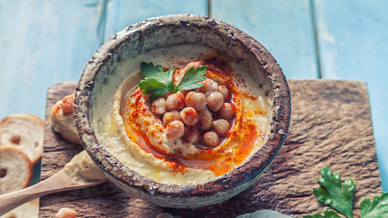 Hummus with dressing drizzle in bowl