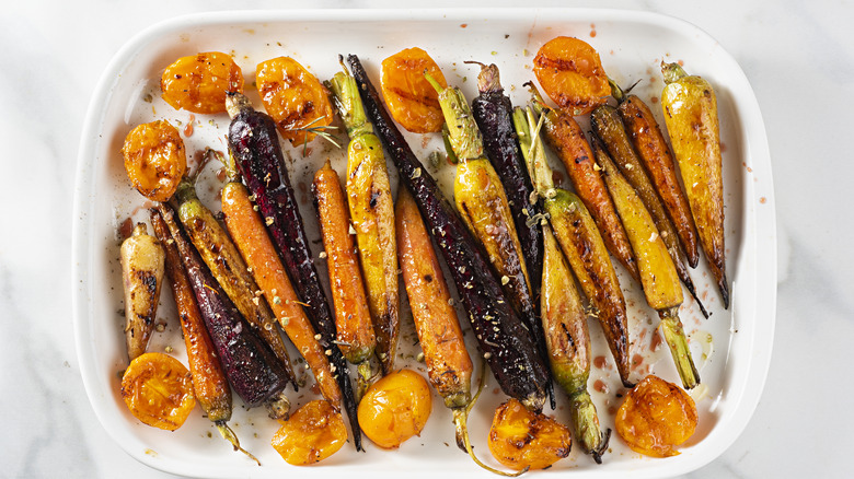 Roasted carrots with seasoning on platter dish