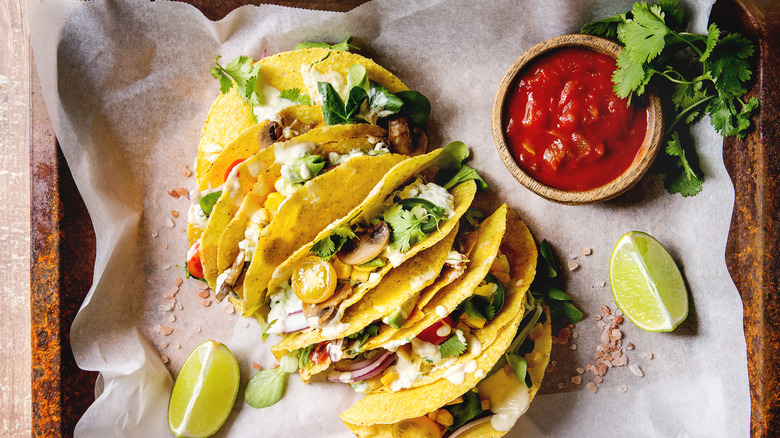 Tacos with creamy dressing on wax paper