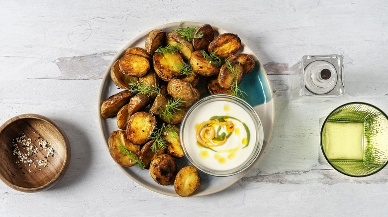 Roasted potatoes with sauce on plate