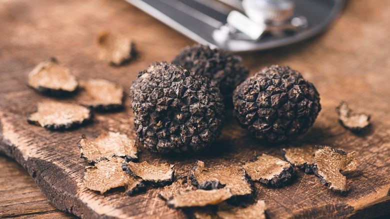 Black truffles on a wooden table