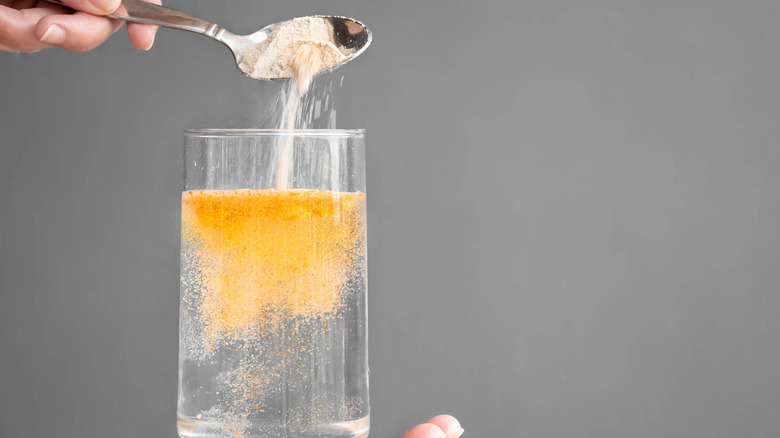 A glass of water with lemon powder