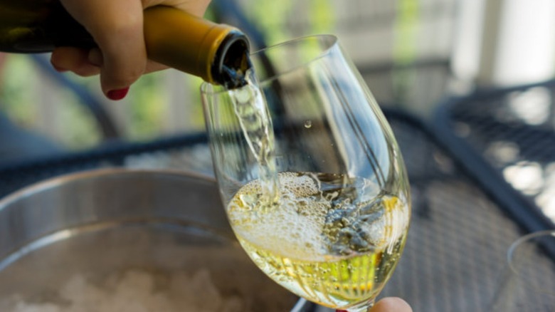 pouring glass of white wine