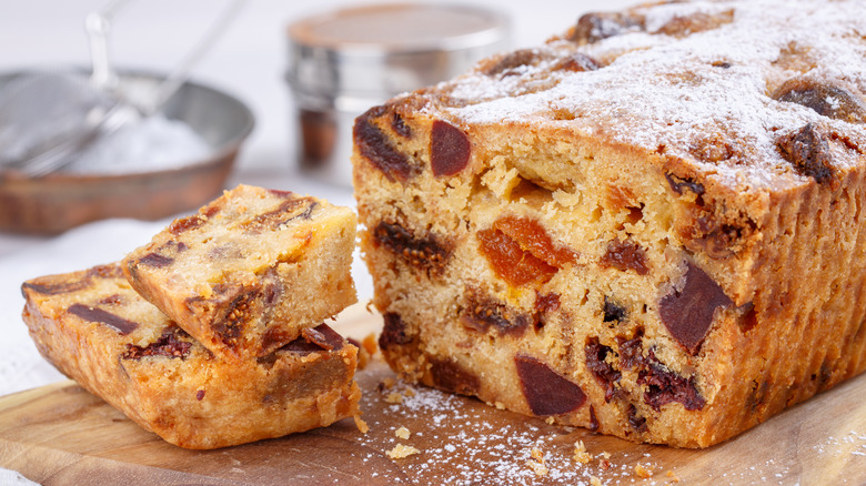 sliced fruitcake with ingredients in background