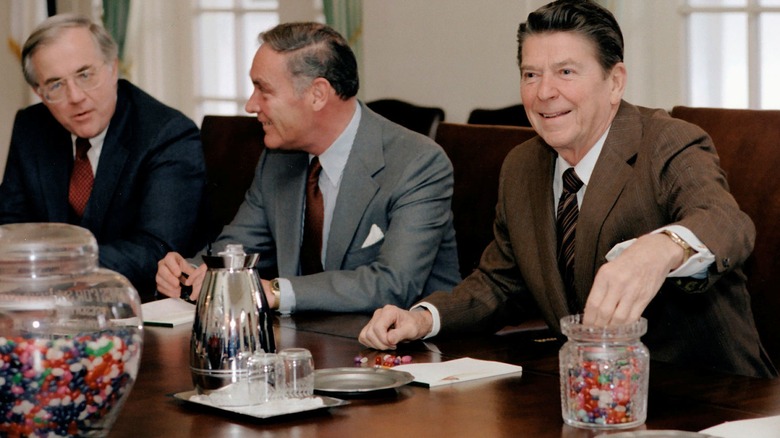 Ronald Reagan with hand in jelly beans container