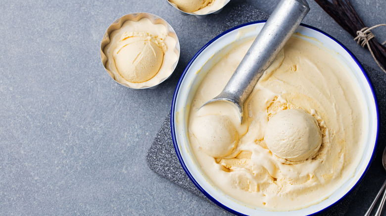 homemade vanilla ice cream being scooped into bowls