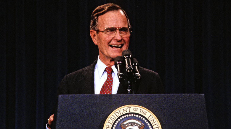 President George H. W. Bush laughing at a conference