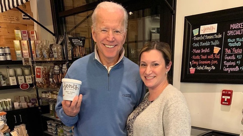 Joe Biden holding a cup of ice cream with the owner at Jeni's Splendid Ice Creams