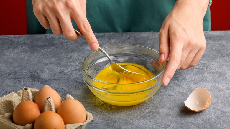 person scrambling eggs