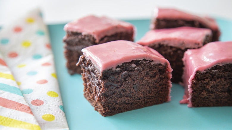 Vegan beet cake with pink icing on plate