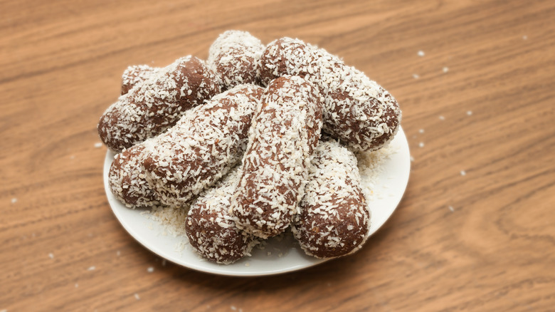 Potato fritters on a table with flaked coconut