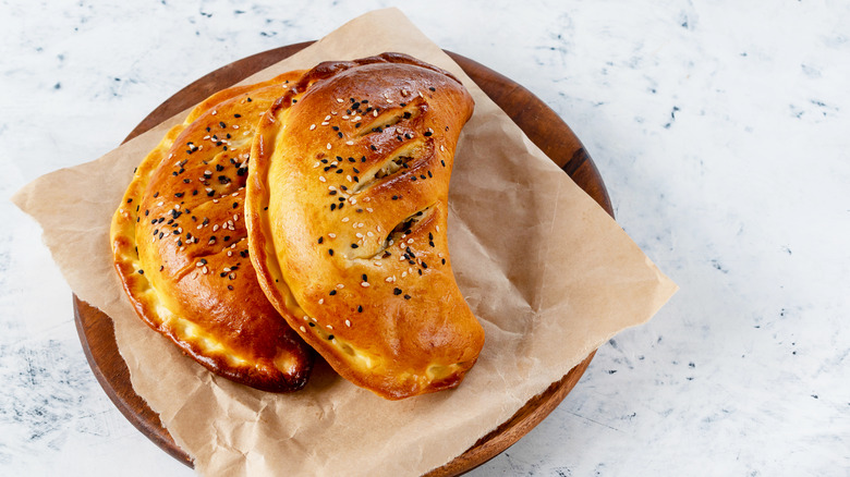 Cornish pasty roll on brown wooden surface