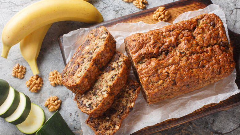 Zucchini bread with bananas and nuts on cutting board