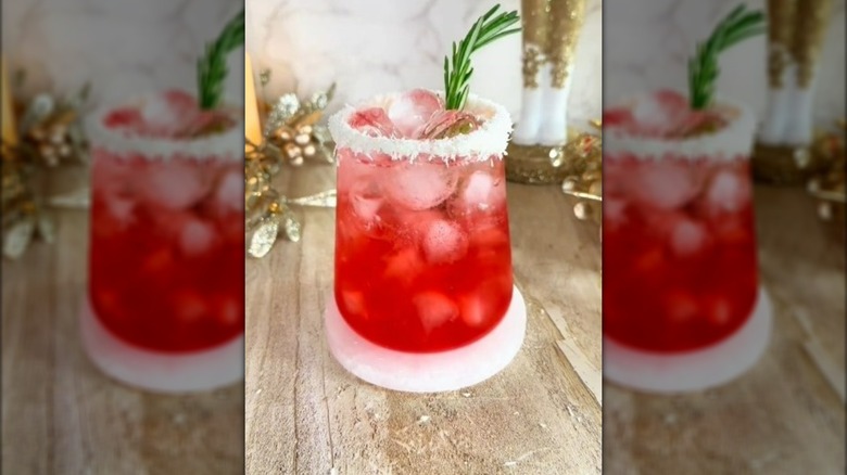 Dirty Santa cocktail with a coconut rim and rosemary sprig