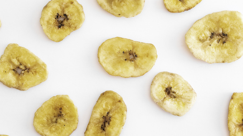 Banana chips on white background 