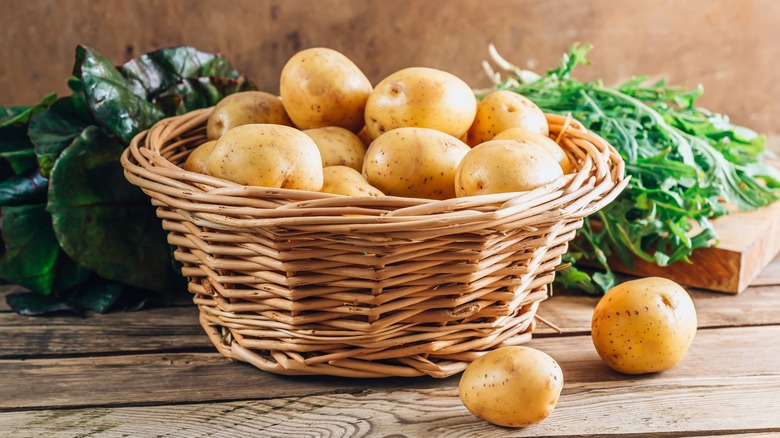 Raw potatoes in a basket