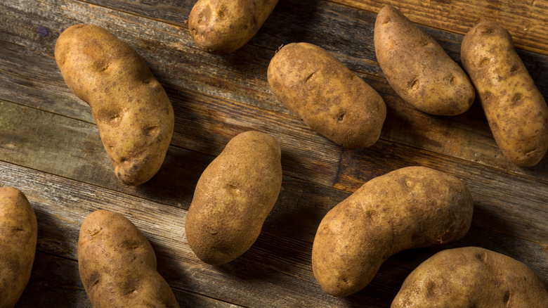 Russet potatoes on wood