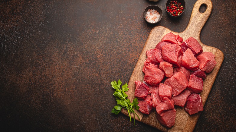 cubed meat on cutting board